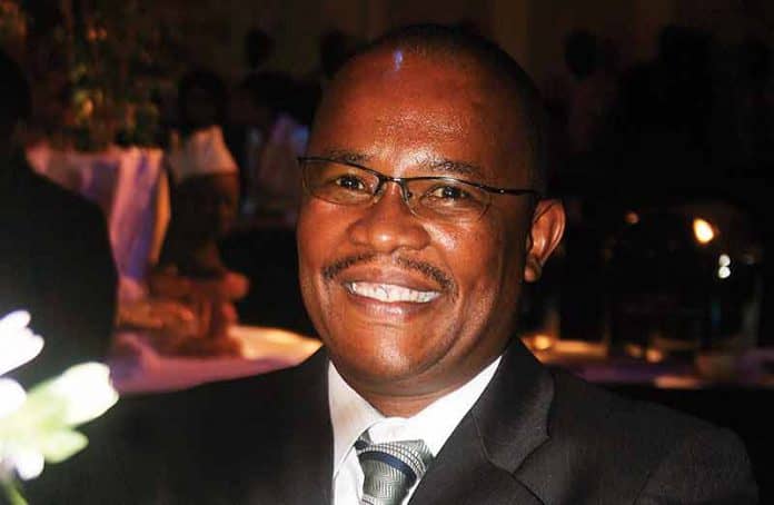 Dr. Matome smiling at a formal event